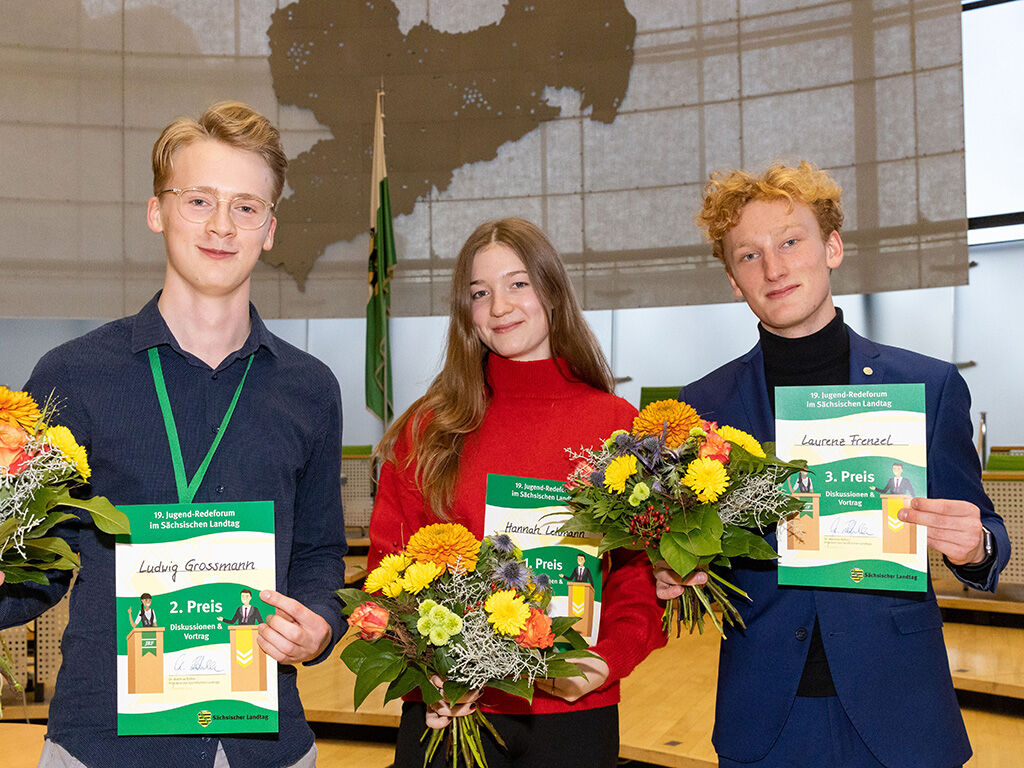 Die Gewinner des 19. Jugend-Redeforums im Landtag mit Urkunde und Blumen: 1. Hannah Lehmann (Mitte), 2. Ludwig Grossmann (links) und 3. Laurenz Frenzel (rechts)