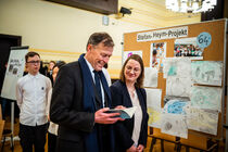 Landtagspräsident Dr. Matthias Rößler schaut sich ein Buch wähend des Besuchs in der Schule an.