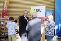 Lars Wurzler im Gespräch mit Besucherinnen vor dem Informationsstand des BSW